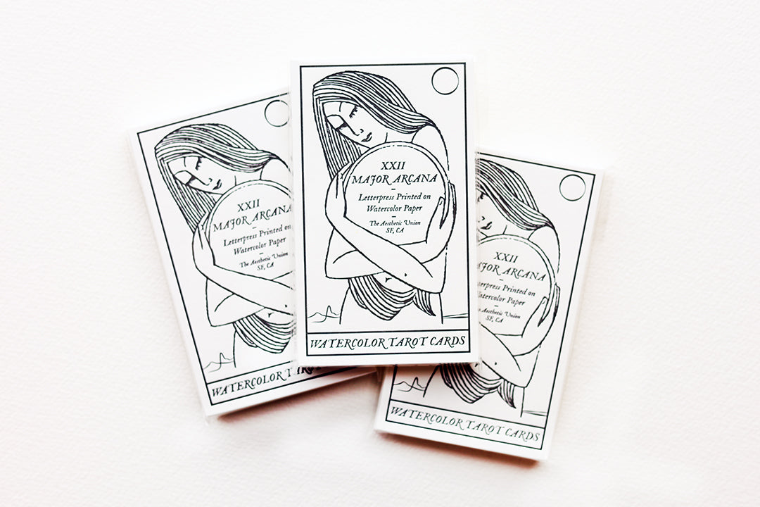 Showing three of the Watercolor Tarot Cards Packs.