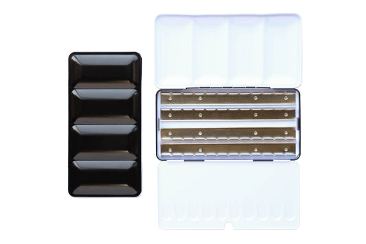 X-Large Empty Palette - a closed palette beside an open palette.  The exterior is shiny black and the inside is shiny white with mixing space in the lids.  Interior shows 4 empty metal rows that the pans of watercolor clip securely into.