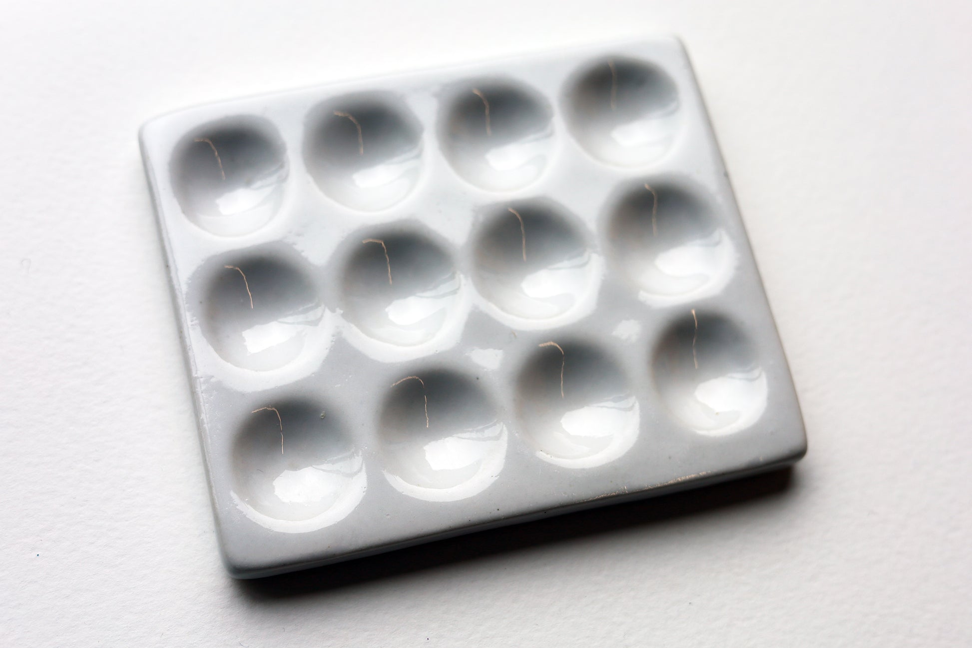 White Porcelain Spot Plate white on white background with 12 wells