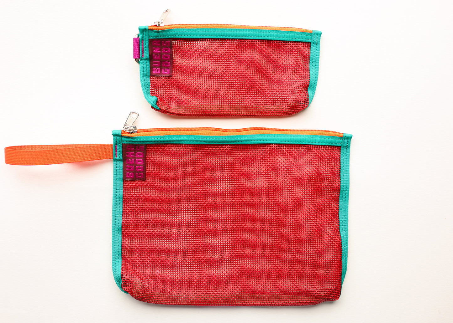 Two mesh zip pouches in red, one small and one medium, with turquoise trim, orange zipper tape, and an orange wrist strap on the larger pouch. Each pouch has a small purple fabric tag with white text that reads 'Buena Goods'.