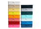 Two stacks of rectangular plastic storage bins with lid clamps, shown in multiple colors including white, beige, yellow, orange, pink, red, blue, and green, on a white background.