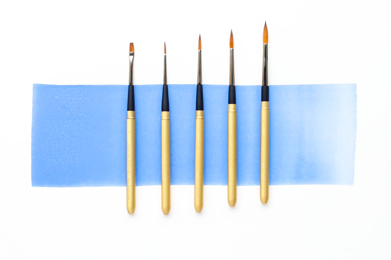Five sizes in a row of Case for Making Matte Gold Travel Brushes.  From left to right: flat size 2, round size 2, round size 4, round size 6, round size 8.