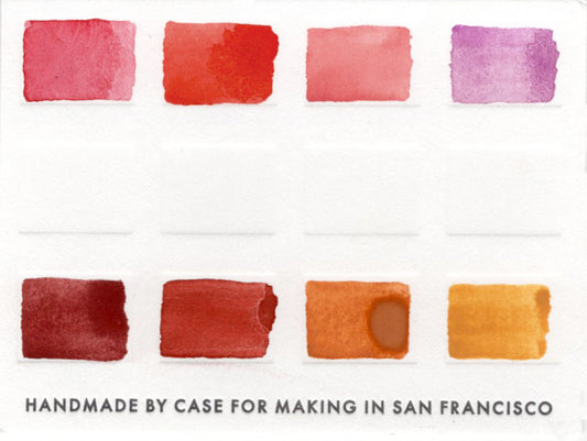 Close-up of the swatch card for the 8 Warm Color Travel Set that features 8 warm toned colors.