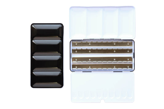 X-Large Empty Palette - a closed palette beside an open palette.  The exterior is shiny black and the inside is shiny white with mixing space in the lids.  Interior shows 4 empty metal rows that the pans of watercolor clip securely into.  